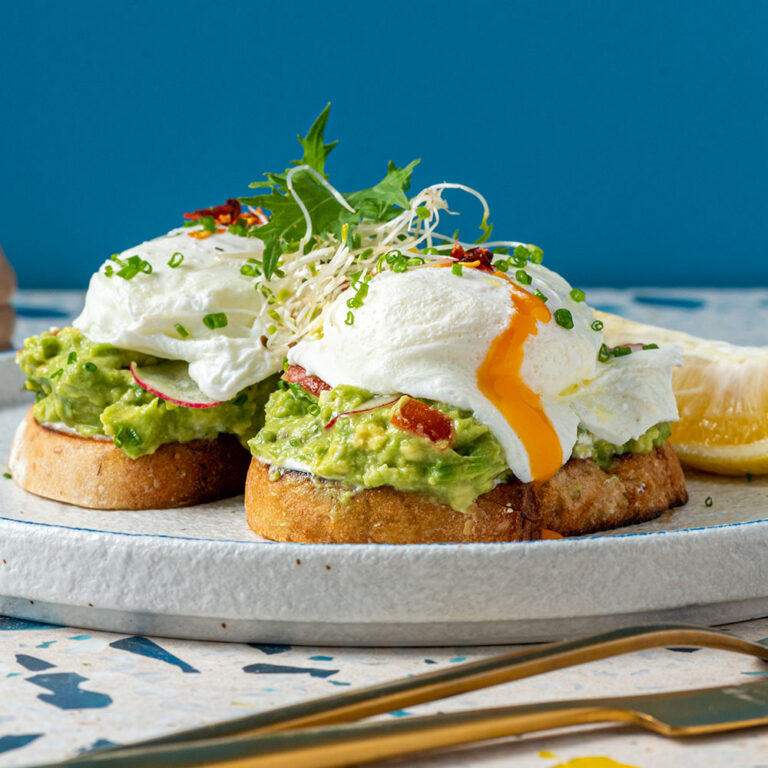 Plate with two slices of toast topped with cream and assorted food